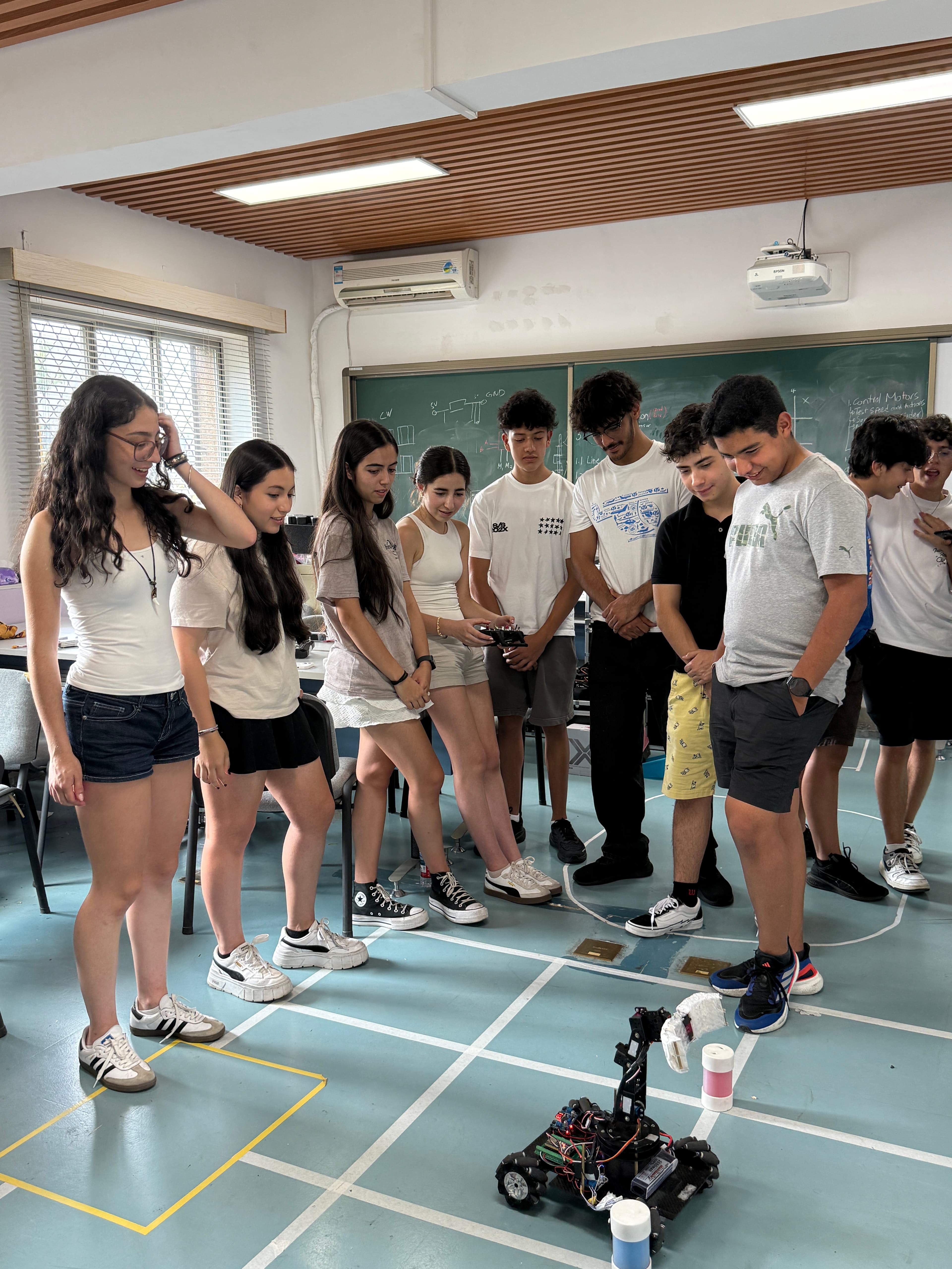 Students interacting during an international robotics exchange