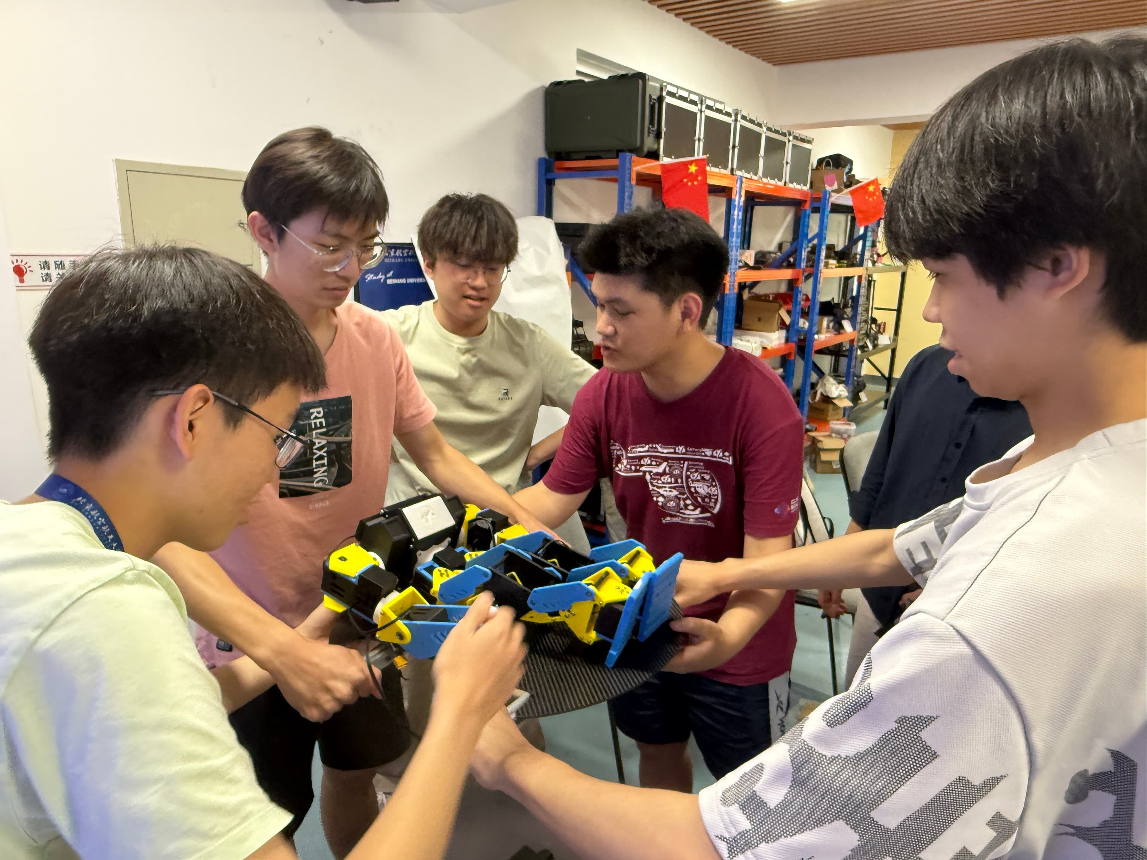 ISRC members assembling and testing a humanoid robot together in the lab